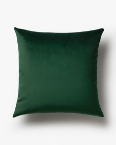 a dark green pillow on a white background with a black border around the edges and bottom part of the pillow