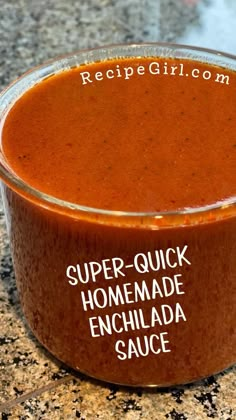 a bowl of homemade enchilada sauce on a granite countertop with the words super - quick homemade enchilada sauce