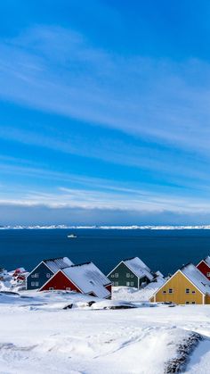 the houses are all covered in snow by the water's edge, and there is no image here to provide a caption for