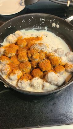 a pan filled with food sitting on top of a stove