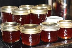 several jars of jam sitting on top of a counter