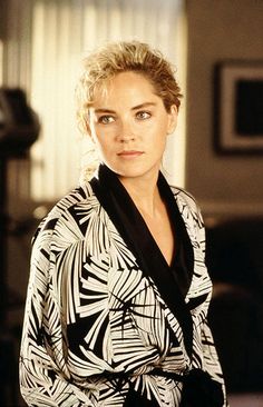 a woman with blonde hair wearing a black and white robe