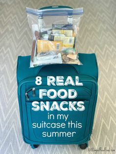 a blue suitcase with food in it and the words 8 real food snacks in my suitcase this summer