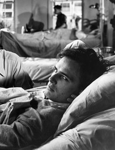 black and white photograph of two men in hospital beds