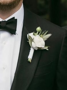 a man in a tuxedo with a boutonniere on his lapel