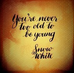 the words you're never too old to be young snow white on a yellow background