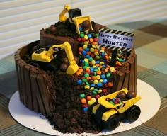 a birthday cake made to look like a dump truck with chocolate frosting and candy