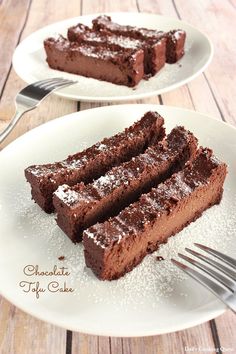 two plates with slices of chocolate cake on them