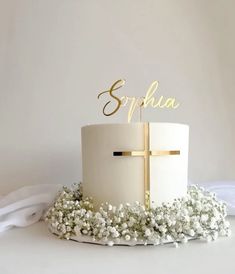 a white cake with a gold cross on top