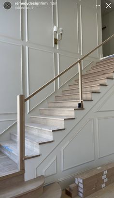 an empty room with some stairs and boxes on the floor in front of white walls