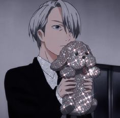 an anime character holding a teddy bear in his hands with sparkles all over it