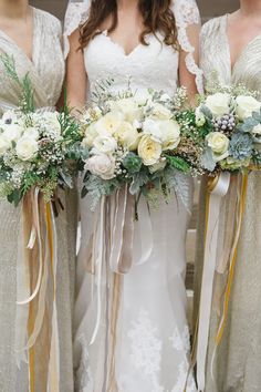 the bridesmaids are holding their bouquets together