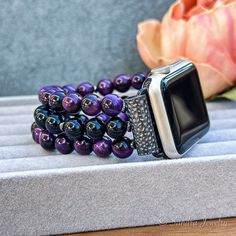 Please note that the length of the bracelet does not include the watch Introducing the IWatch Handmade Replacement Band - an exquisite fusion of craftsmanship and sophistication tailored for Apple Watches. This artisanal watch band is meticulously crafted with genuine Purple Tiger Eye stone and a striking Black Onyx middle row, creating a distinctive accessory that effortlessly combines style and functionality. Choose from a spectrum of connector colors - black, silver, and rose gold - to seamle Elegant Beaded Apple Watch Band As Gift, Elegant Adjustable Apple Watch Band With Round Beads, Elegant Adjustable Beaded Watch Bands, Purple Tiger, Apple Watch Bracelet, Apple Watch Bracelets, Apple Watches, Apple Watch Models, Watch Bracelet