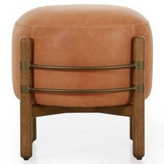 a tan leather ottoman with wooden legs