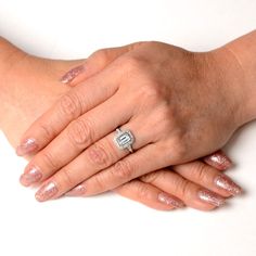 two hands are holding each other while one holds the other's hand with a diamond ring on it