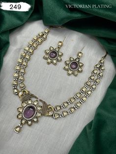 Traditional Purple Moissanite Kundan Kamal Victorian Necklace Set for Women Discover the epitome of opulence and traditional elegance with our Traditional Purple Moissanite Kundan Kamal Victorian Necklace Set. Designed for the modern woman who cherishes the grandeur of Bollywood and bridal fashion, this exquisite jewelry set seamlessly blends classic Kundan artistry with contemporary sophistication. Central to the design is the Kamal (lotus) motif, a symbol of purity, beauty, and rebirth in Indi Elegant Dual-tone Kundan Necklace, Elegant Dual-tone Kundan Necklace For Wedding, Elegant Purple Kundan Necklace For Festive Occasions, Elegant Festive Dual-tone Necklace, Festive Elegant Dual-tone Necklace, Elegant Purple Kundan Necklace As Gift, Festive Dual-tone Kundan Necklace For Celebration, Bollywood Style Dual-tone Kundan Necklace For Wedding, Festive Dual-tone Elegant Bridal Necklace