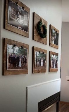 the wall is decorated with pictures and wreaths on it's sides, along with a fireplace mantel