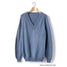 a blue sweater hanging on a wooden hanger