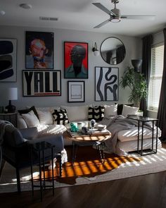 a living room filled with furniture and pictures on the wall