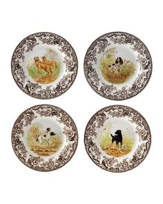 four plates with dogs painted on them