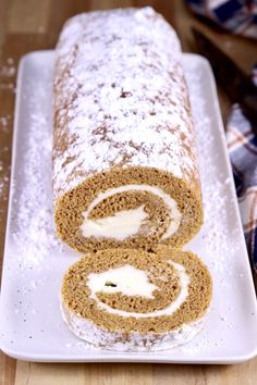 there is a roll on the plate with powdered sugar