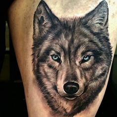 a wolf tattoo on the thigh