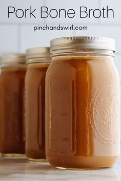 three jars filled with peanut butter sitting on top of a counter