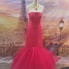 a mannequin wearing a red dress in front of the eiffel tower