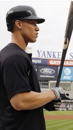 a man holding a baseball bat on top of a field