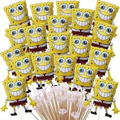 a bunch of spongebob lollipops are arranged on top of sticks