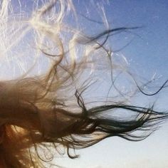 a woman with her hair blowing in the wind