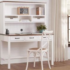 a white desk and chair in front of a book shelf with books on top of it