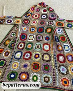 a crocheted granny's afghan with multicolored circles on it