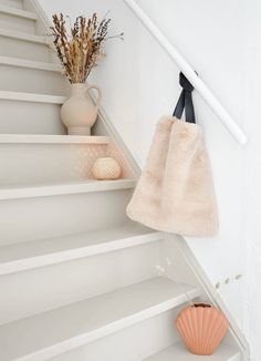 a towel hanging on the wall next to some stairs