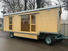 a tiny house on wheels is parked in the driveway