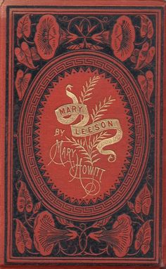 an old red book with gold lettering on the front and back cover, featuring a snake