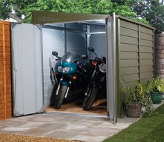 a motorcycle is parked in the side of a garage with its door open and it's motorbike inside