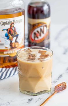 a glass filled with ice cream next to two bottles of captain morgan's coffee