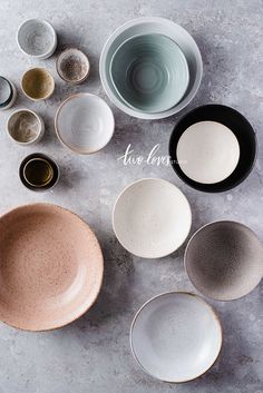 various bowls and plates are arranged on a table top with the words how love is written above them