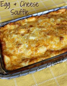 an egg and cheese casserole in a glass dish on a yellow tablecloth