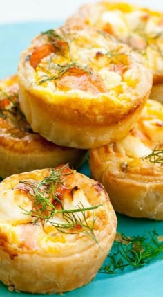 small quiches with cheese and herbs on a blue plate