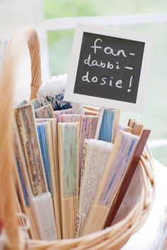 a basket filled with lots of books on top of a table