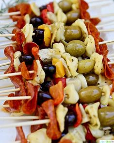 several skewers filled with olives, peppers and cheese on toothpicks