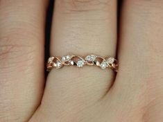 a woman's hand with a diamond ring on it