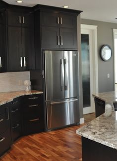 a large kitchen with granite counter tops and stainless steel refrigerator freezer, oven and dishwasher