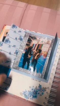 a person is holding a book open to show pictures on the cover and inside it