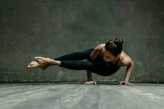 a woman is doing yoga on the floor