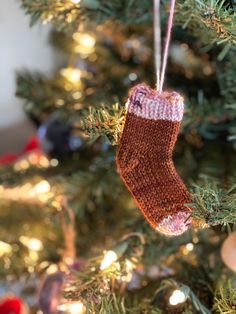 an ornament hanging from a christmas tree in the shape of a stocking