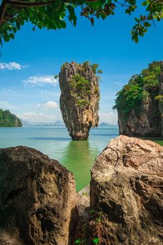 two large rocks sitting on top of a body of water