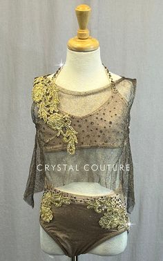 This unique custom costume is full of beautiful details. Starting with Nude lycra as the base for the bra top and trunks then an added metallic Gold and Brown mesh cropped tunic top, with solid rhinestoned Gold floral applique at the shoulder. Trunks also covered in Gold metallic and brown mesh with Gold rhinestoned appliques following the seams all the way around. This costume has over 9 gross of rhinestones in Light Peach, Greige and Crystal Silver Shade and was beautifully constructed in ever Fitted Gold Sets For Costume Party, Festival Embellished Fitted Choli, Fitted Embellished Choli For Festival, Fitted Belly Dance Sets For Party, Embellished Fitted Festival Sets, Fitted Embellished Sets For Festivals, Embellished Fitted Sets For Festival, Trio Costumes, Sequin Jewelry